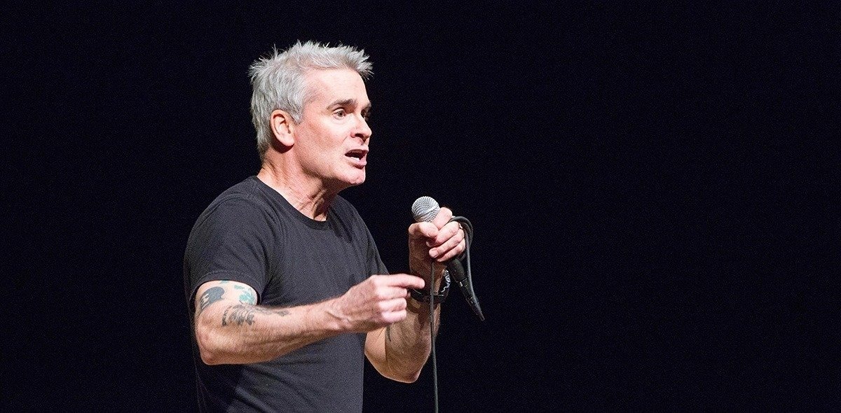 Henry Rollins speaking into a microphone