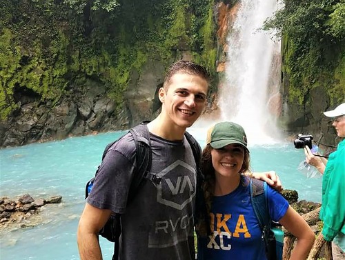 Image of students smiling in front of waterfall