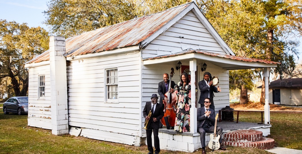 Ranky Tanky band members standing on porch of house