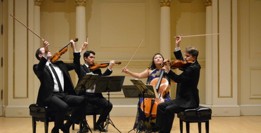Calidore String Quartet playing in concert