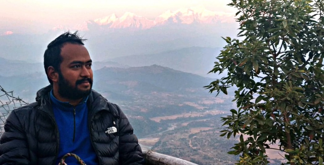 Biplap Karki with mountains in background