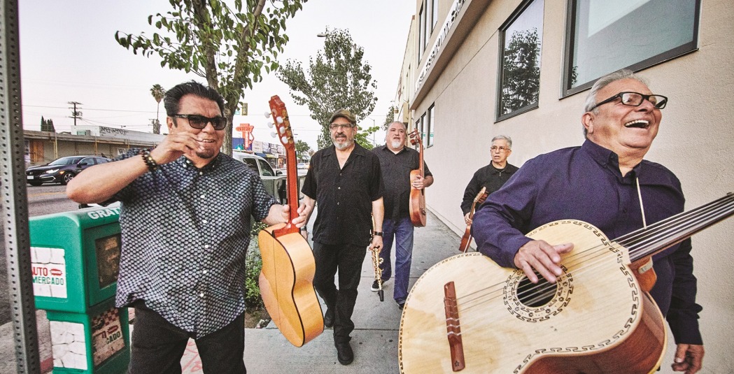 Los Lobos walking on sidewalk