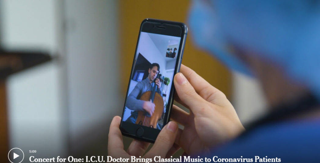 Person holding cell phone with a musician playing up to a patient