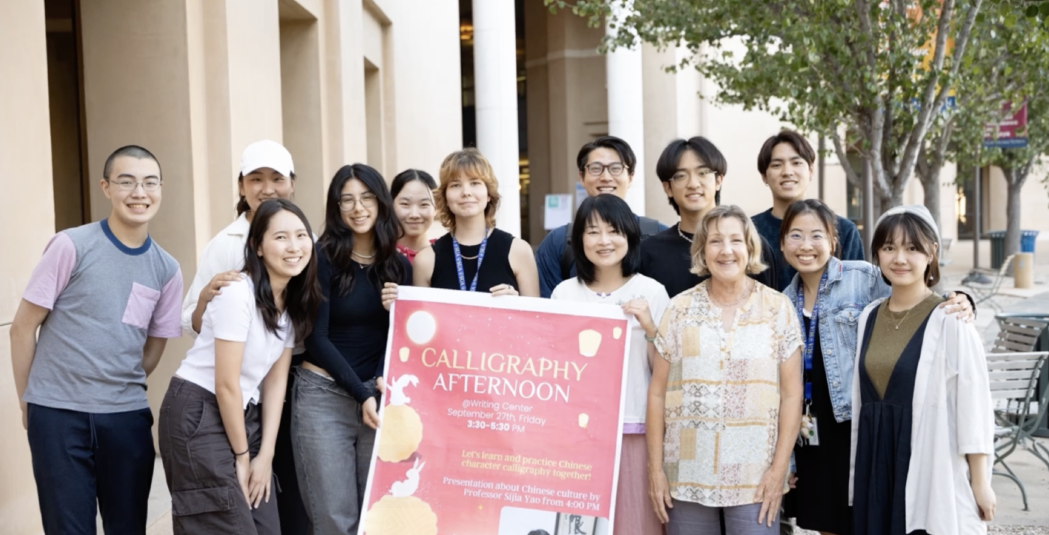 Students take a group photo during a writing center event.