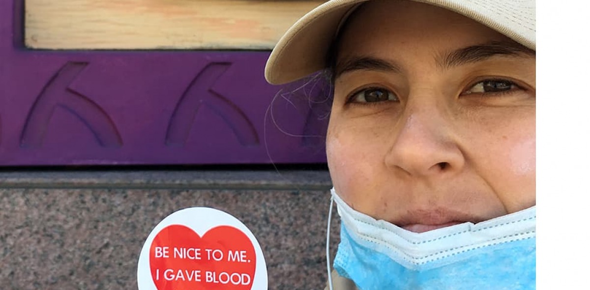 Victoria Kraus holding an "I gave blood today" sticker