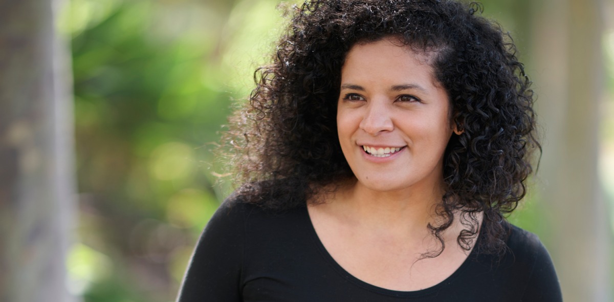 Jacqueline Cid poses outside wearing a black shirt for the Women of SUA photoshoot