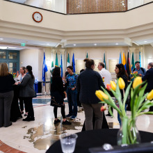 Gallery opening attendees mingle in Founders Hall atrium before entering the exhibition.