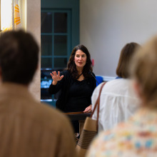 Carolyn Monastra speaks to gallery opening attendees