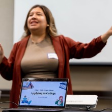 A woman gives a presentation called "What I Wish I Knew About Applying to College"