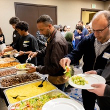 College Night attendees serve themselves food from the buffet line
