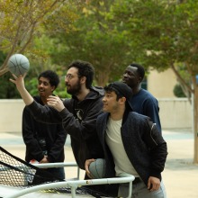 Four people shoot basketball during the 2025 Homecoming event