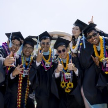 Soka graduates pose together in their cap and gowns on Commencement Day 2025