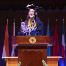Julia Miyagawa Braga holds the award she received from President Ed Feasel
