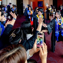 Graduates walk out of the Performing Arts Center after commencement.