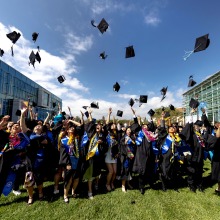 The Class of 2024 throws their graduation caps in the air to celebrate their commencement.