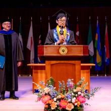 A student speaker addresses the crowd during commencement.