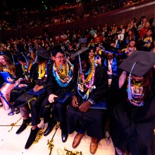 Excited graduates talk amongst themselves during commencement.