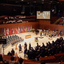 The graduates begin walking out of the Performing Arts Center during their recessional