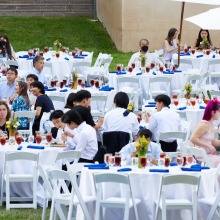 The Class of 2026 sit at circular white tables on the Campus Green during the Welcome Reception