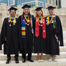 Four Graduate Students pose together for a photo