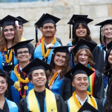 Graduates pose in their caps and gowns on commencement day