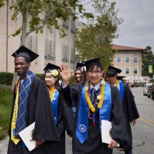 Graduates walk out of commencement after the ceremony.