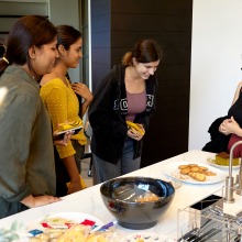Students and staff share a laugh at a table in the new Global Language and Culture Center