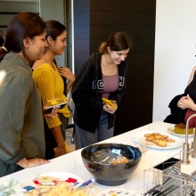 Students and staff share a laugh at a table in the new Global Language and Culture Center