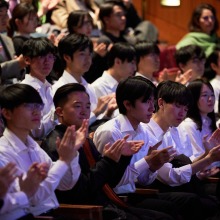 Students clap at the memorial service for Daisaku Ikeda