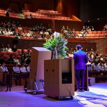 A speaker talks to the crowd remembering Daisaku Ikeda
