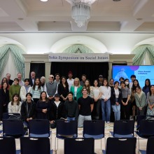 The attendees and presenters of the symposium pose together for a group photo