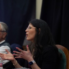 One of the experts gestures with her hands as she speaks during the symposium