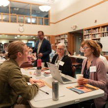 Conference attendees engage in a spirited discussion.