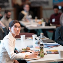Conference attendees take notes and listen intently during the conference.