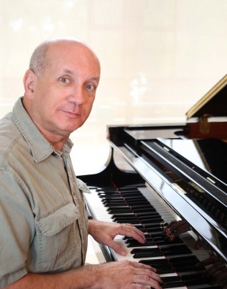 Michael Golden sits at a piano