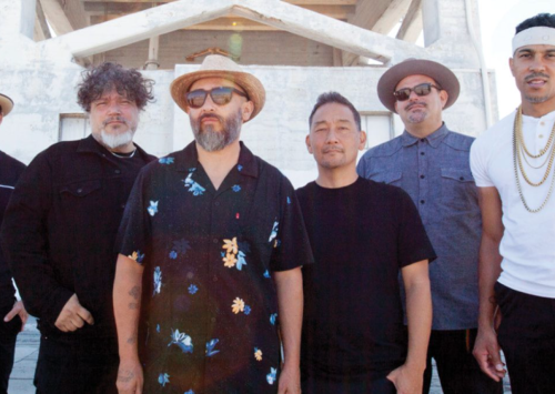Five men in Ozomatli band standing looking at camera