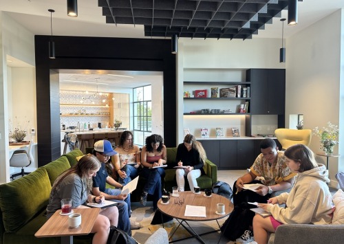 A large group of students sit together in the Global Language and Culture Center