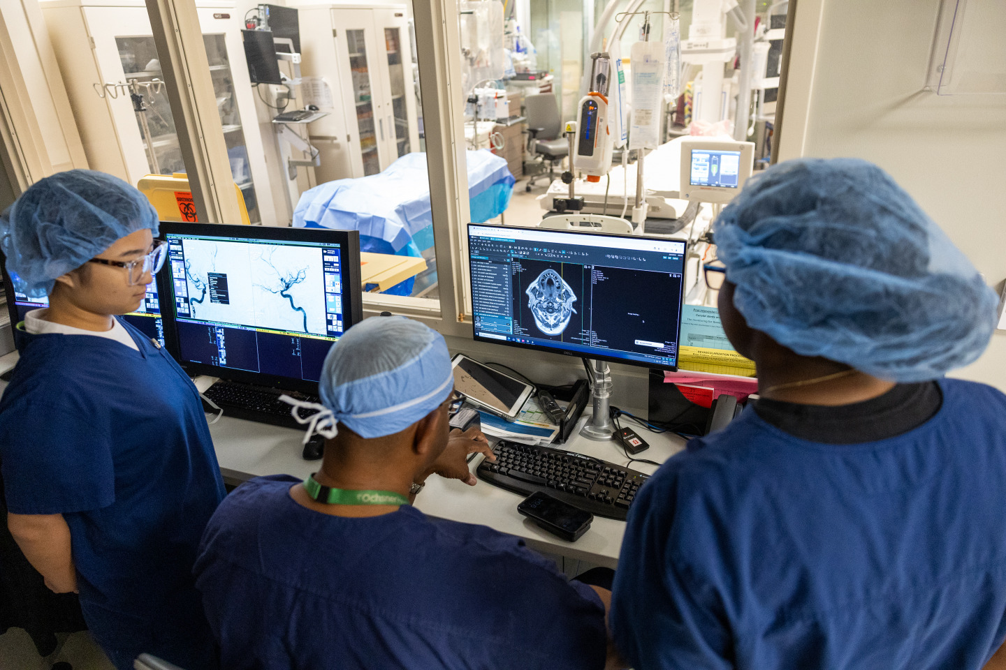 Students and their instructor look at scans during their clinical neurosurgery preceptorship