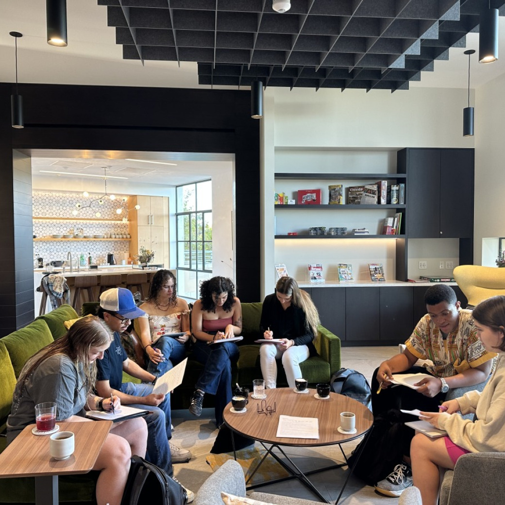A large group of students sit together in the Global Language and Culture Center