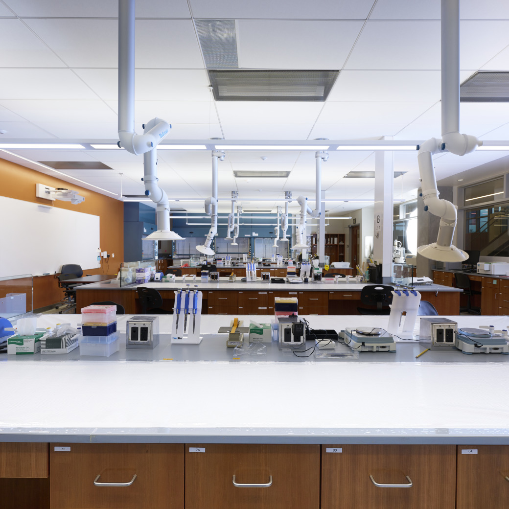 Lab equipment sits idly in an empty lab classroom.