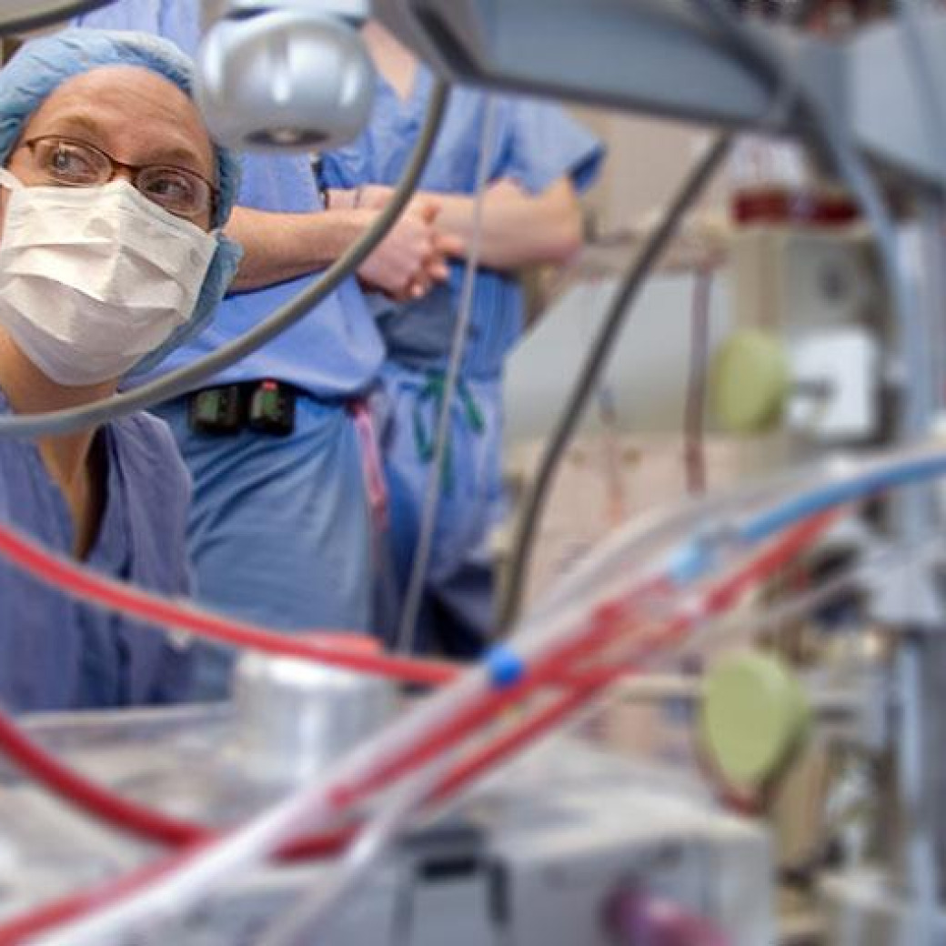Cardiovascular perfusionists monitoring a machine during surgery