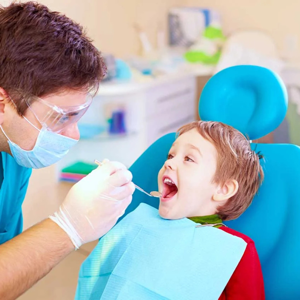A dentist examining a kid's teeth