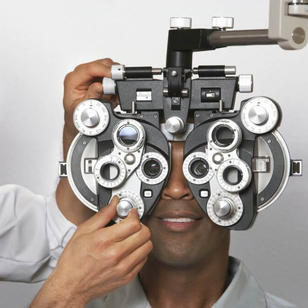A man sitting behind the phoropter