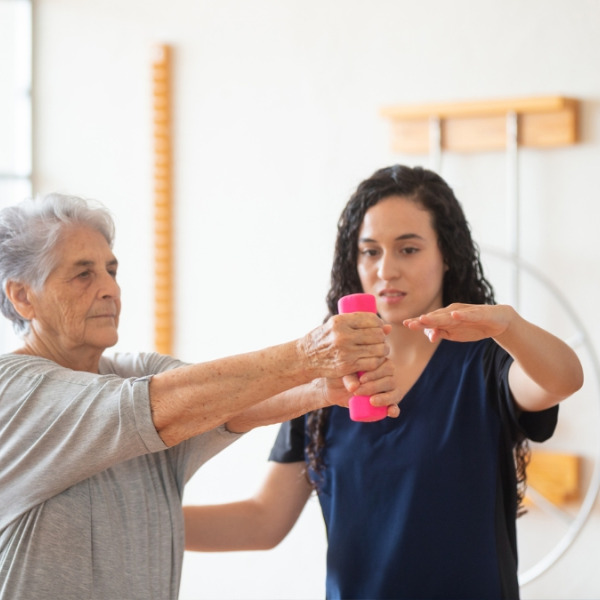 An OT helping an elderly woman