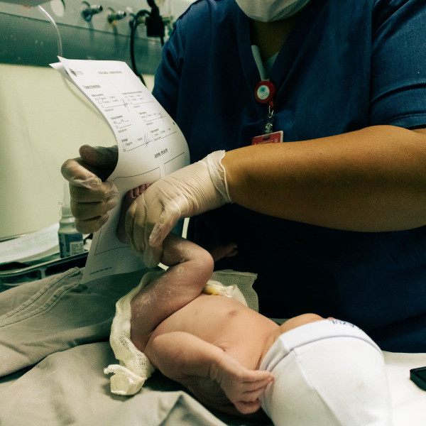 A nurse getting the footprint for a newborn