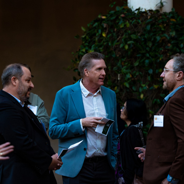 Three conference attendees talking to each other in an outside setting