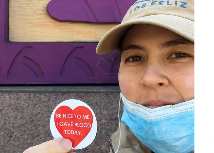 Victoria Kraus holding an "I gave blood today" sticker