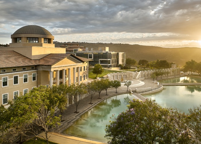 Aerial View of Founder's Hall and Peace Lake with the sun beaming on the horizon