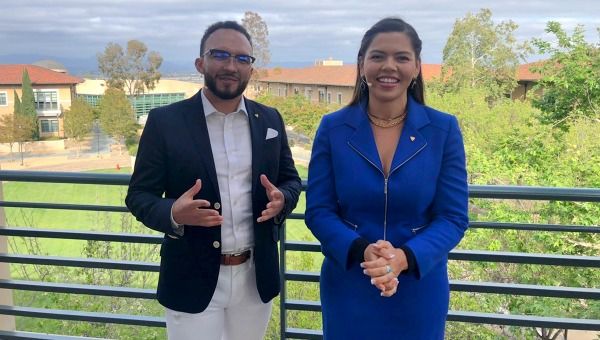 Celebration hosts with campus backdrop