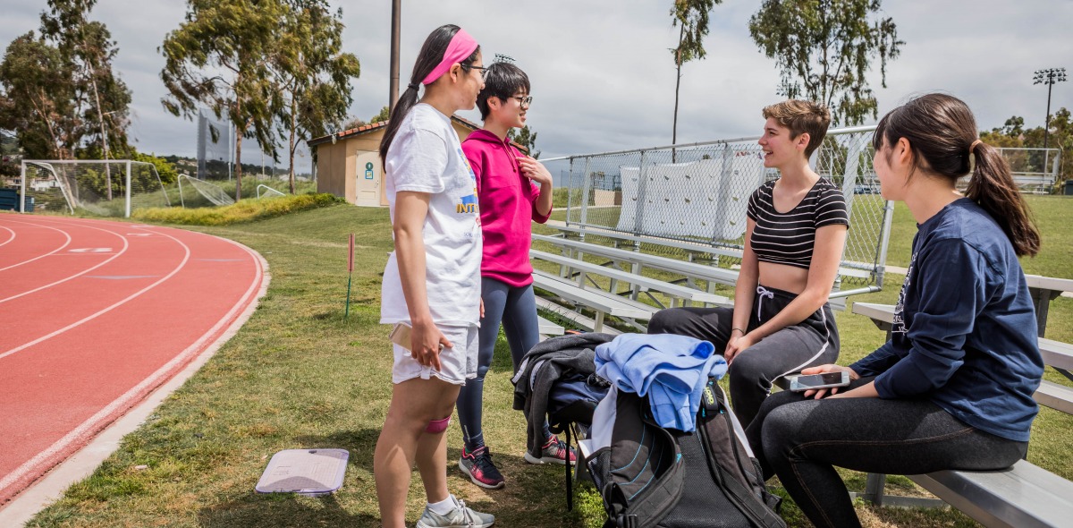 Image of students talking alongside the track.